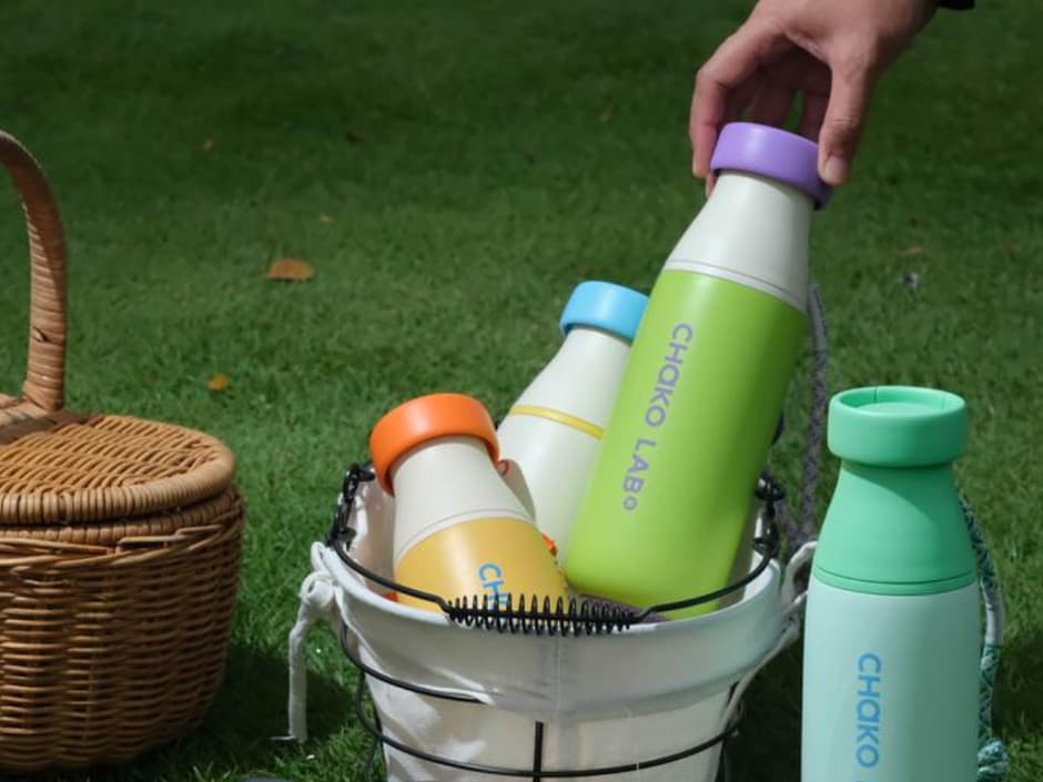 Chako Lab bottles tucked into a picnic basket on the grass